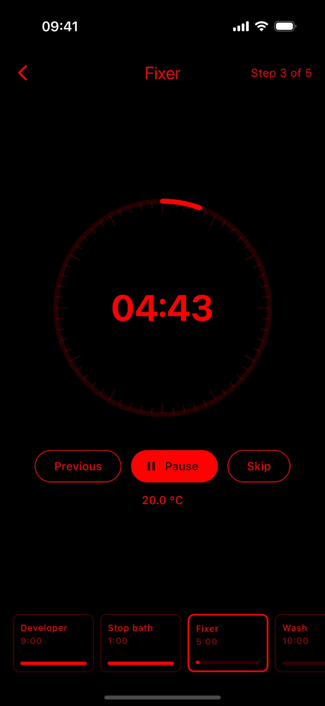 Development runner on iPhone in the red darkroom theme, recorded: the fixer countdown running, paused, and resumed.